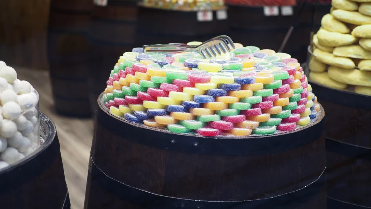 Colorful Jelly Candies Displayed in Wooden Barrels