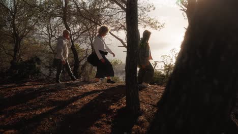 group of friends walking in the forest in a cliff with sea views, evening sunset lifestyle