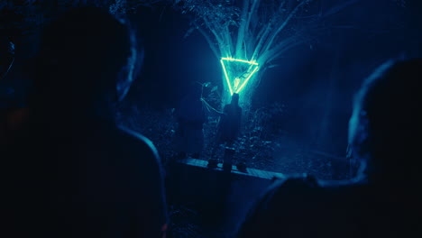 nighttime ritual under illuminated triangle