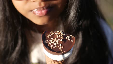 child enjoying a chocolate ice cream cone