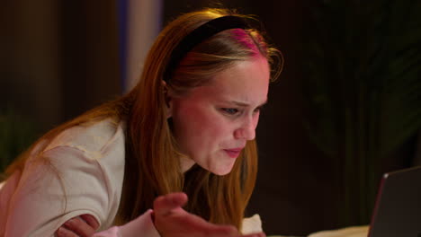 young woman talking on laptop