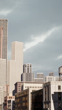 a view of a city skyline with tall buildings and cloudy sky