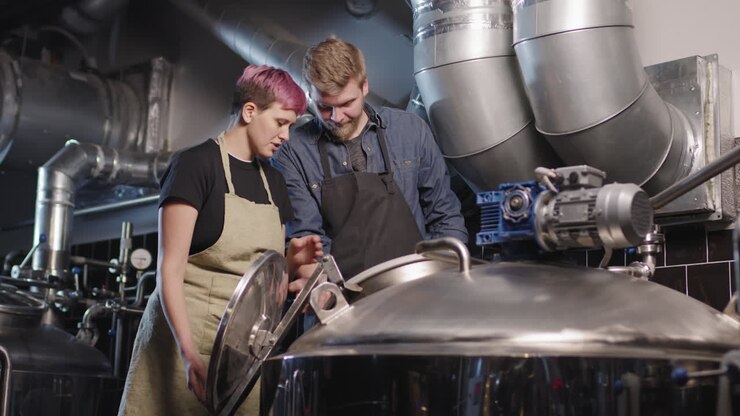 Brewery Workers Opening Brew Kettle
