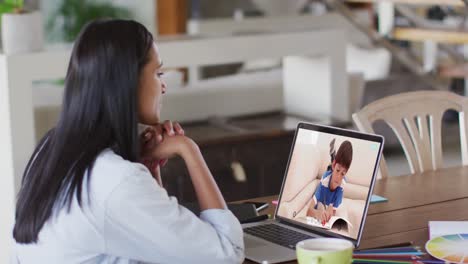 Caucasian-female-teacher-using-laptop-on-video-call-with-schoolboy