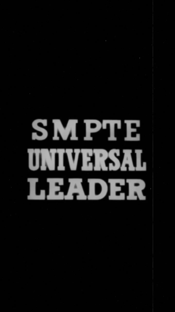 Vertical video of a vintage damaged analog SMPTE universal film leader.
