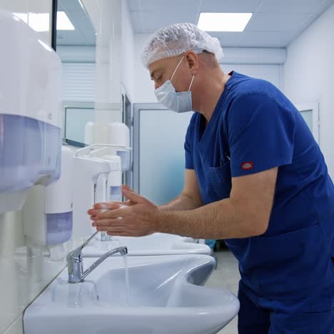 doctor washing hands in hospital. side view of professional doctorr washing hands before surgery