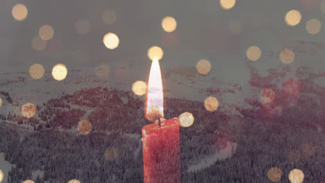 composición digital de una vela ardiente y puntos de luz contra el paisaje de nieve