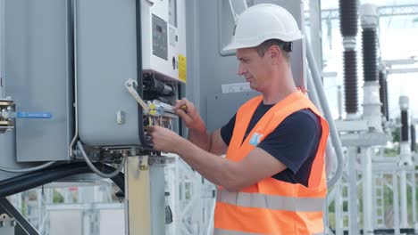 electrical engineers inspect the electrical systems at the equipment control cabinet