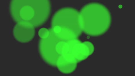 Green-glitters-and-particles-on-black-background