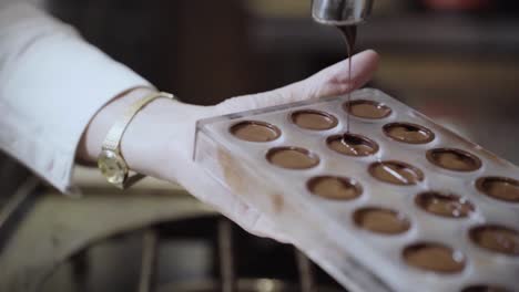 pouring melted chocolate into mould