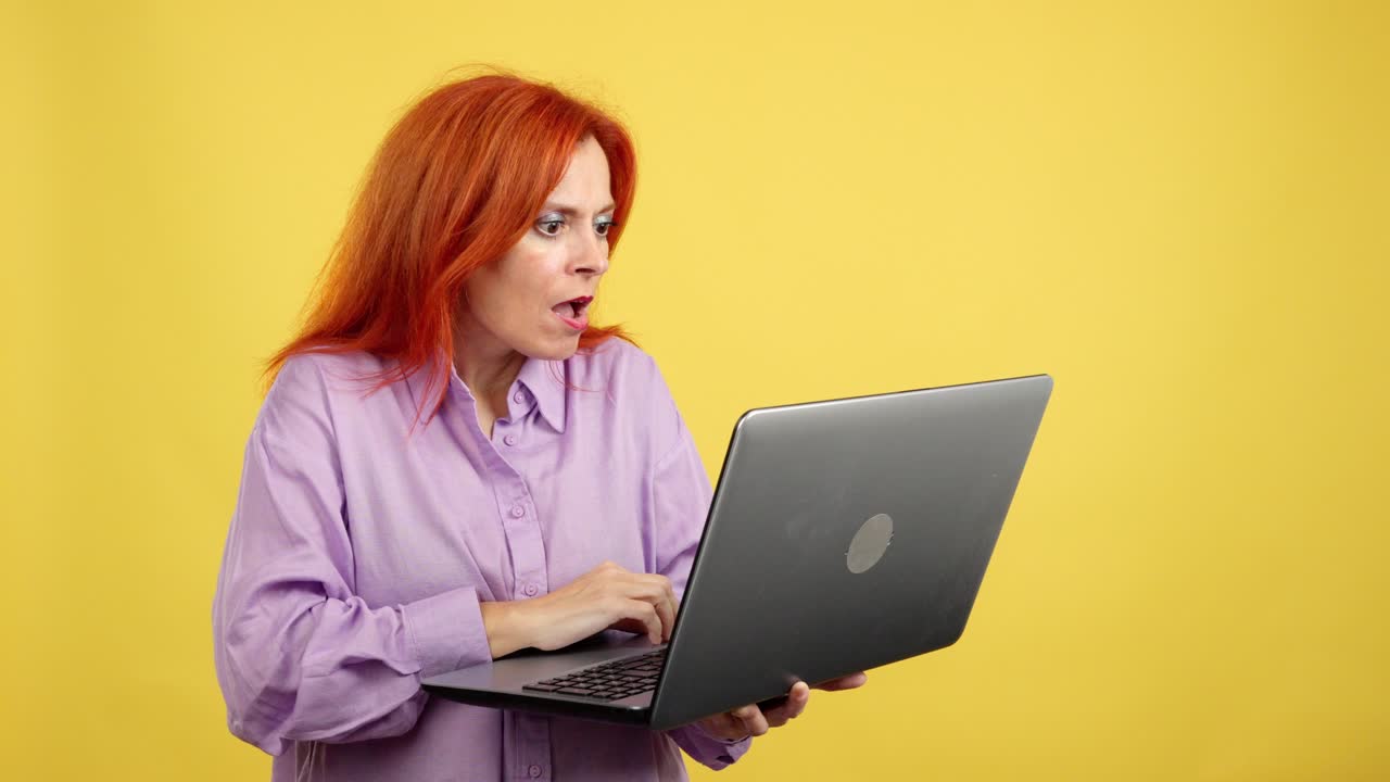 Surprised woman looking at laptop