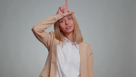 business woman showing loser gesture blaming accusing for unsuccess, expressing disrespect, bullying