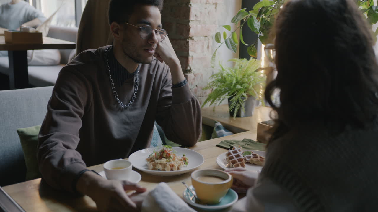 Couple enjoying a breakfast date in a cafe