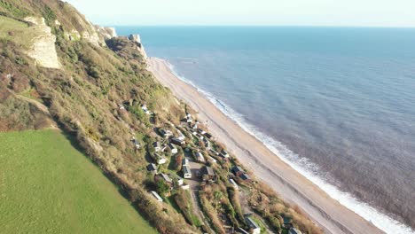 aerial view of branscombe village with holiday homes nestled on a picturesque hillside by the sea in devon, uk