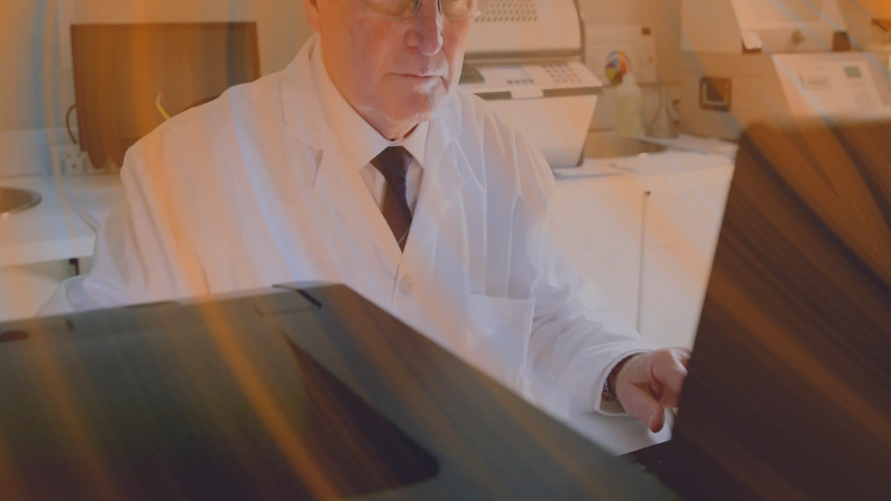Senior lab technician leaning over medical scanner in lab, with animated panel icons floating
