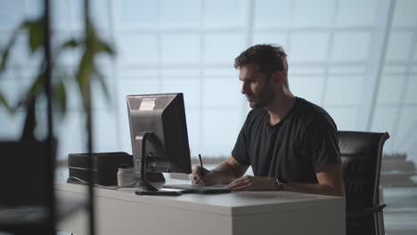 dedication is what earns the best results. businessman in office working at desk on laptop. man student writer sit at office desk with laptop thinking of inspiration search problem solution ideas