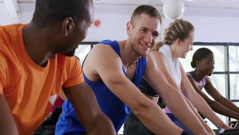 working out on exercise bikes at a gym