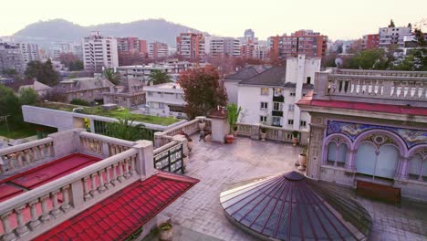 Drone-shot-of-the-roof-of-the-Falabella-Palace-with-elaborate-Florentine-mosaics-and-a-residential-neighborhood-in-Providencia-Santiago-Chile