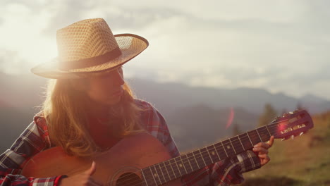 closeup musical woman play guitar instrument in mountains. girl compose music.