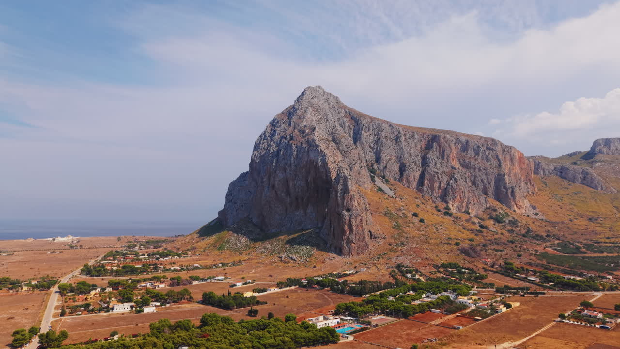 Aerial view of a mountain landscape with a town near the sea