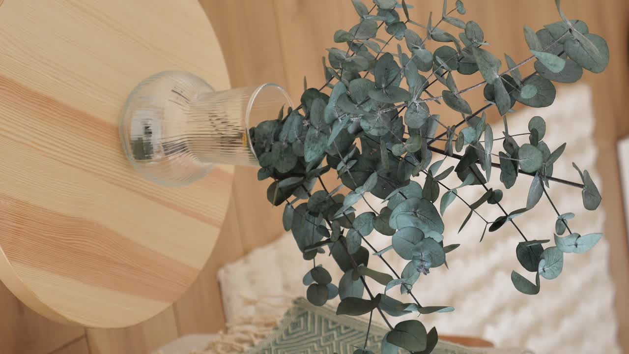 Eucalyptus in a Glass Vase on a Round Table
