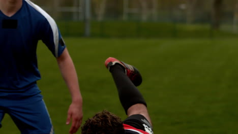 football players tackling for the ball during game