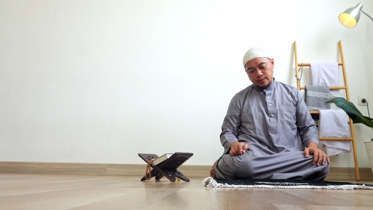 Young Asian Muslim Man Hands Pointing With Index Finger Doing Last Movement Of Praying Salah