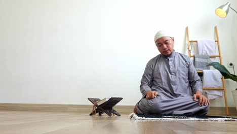 young asian muslim man hands pointing with index finger doing last movement of praying salah