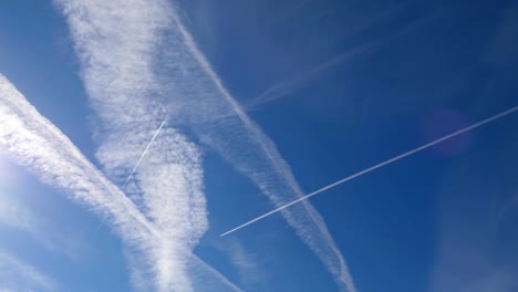 airplanes and contrails in the blue sky lens flare