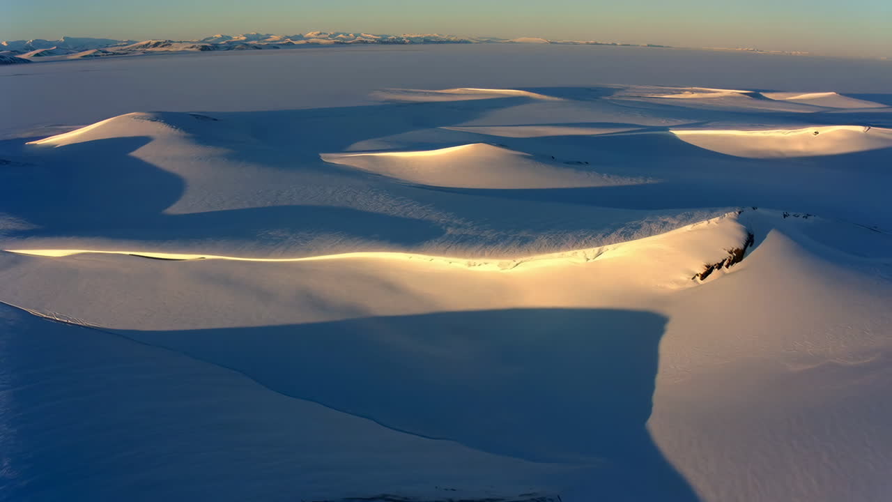 Aerial View of Snow-Covered Mountains with Golden Light