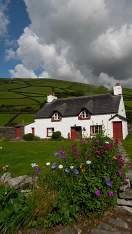 charming cottage in a lush green landscape with flowers