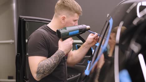 man covering car with vinyl polyurethane tape. films for the car. sticker protective film on the car