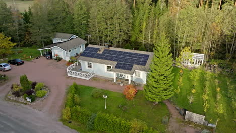 aerial view away from a solar powered home in middle of fall colored forest