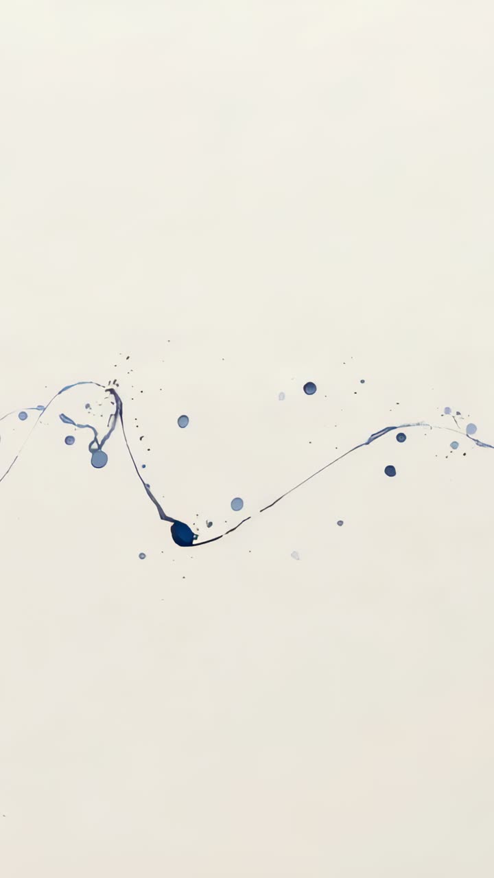 Vertical video: Moving from left, blue ink stroke forming loops across cream paper, droplets specks