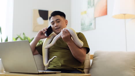 Man-with-snake-talking-on-the-phone