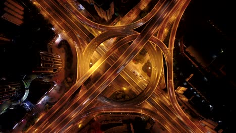 hyper lapse of aerial view of highway junctions with roundabout. bridge roads shape circle in structure of architecture and transportation concept. top view. urban city, shanghai at night, china.
