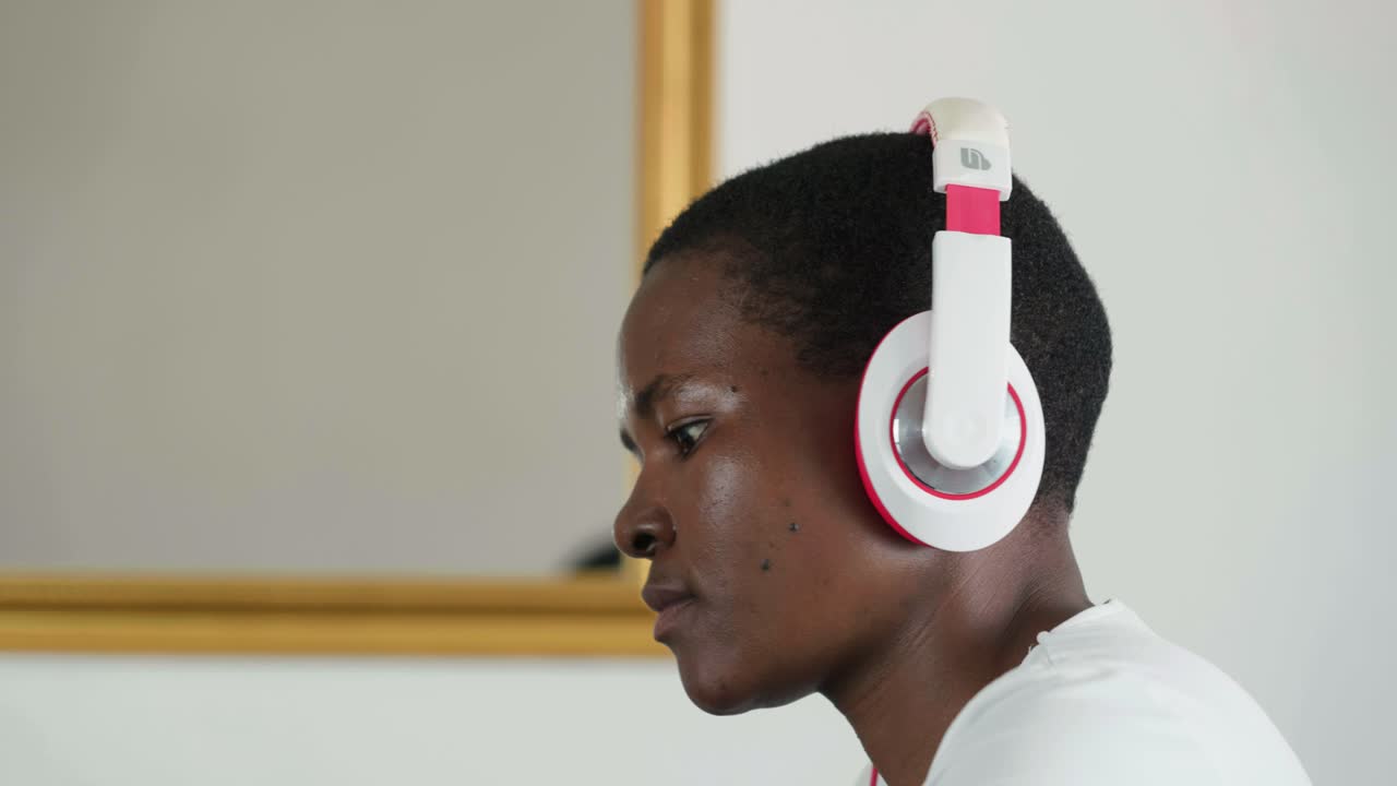 African lady wearing earphones while working