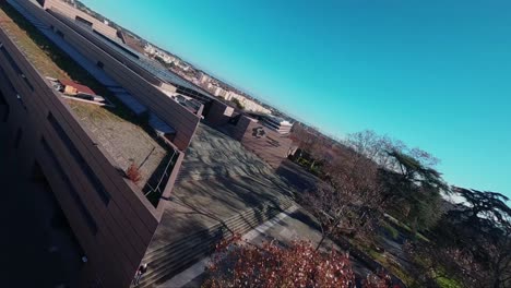 Cinematic-acrobatic-FPV-shot-flying-past-flags-outside-le-Corum-in-Montpellier