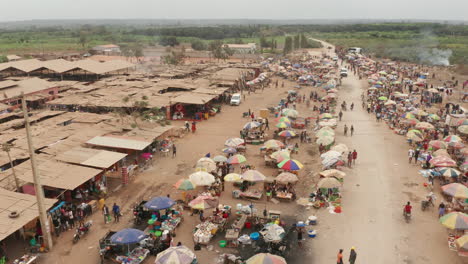 traveling-front-over-the-informal-market,-Caxito-in-Angola,-Africa-1