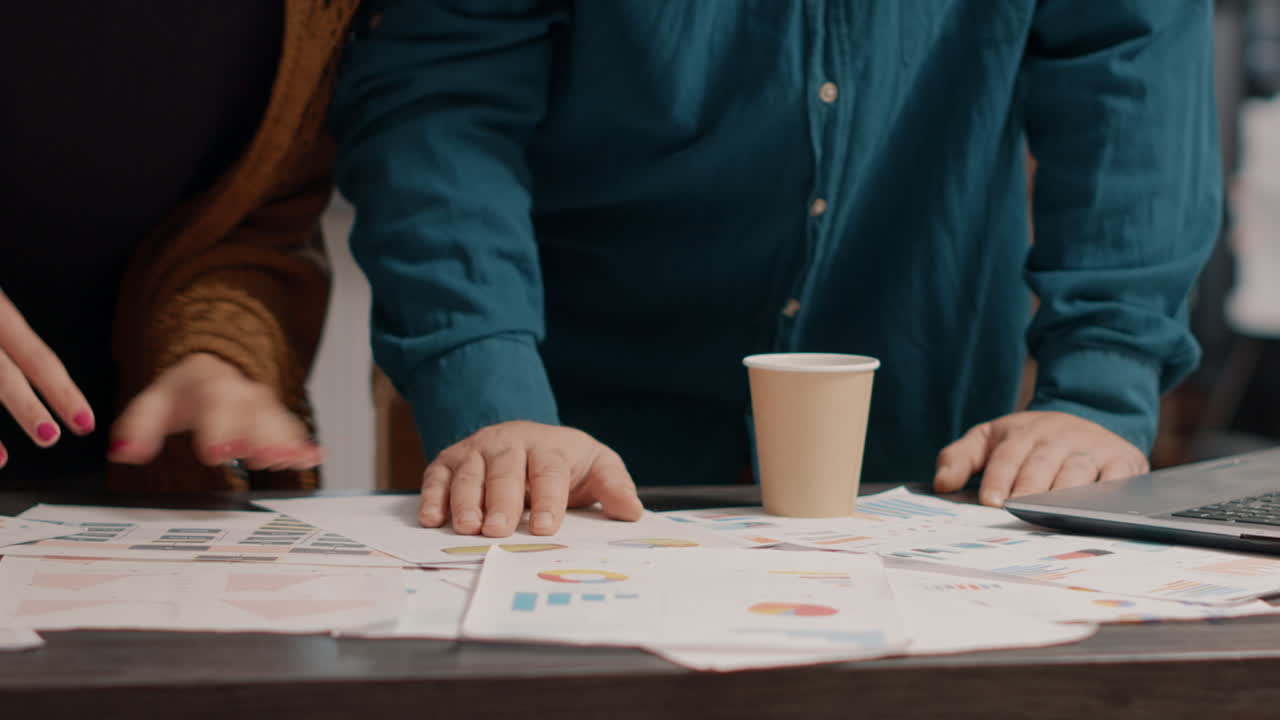 Team analyzing pie charts and graphs