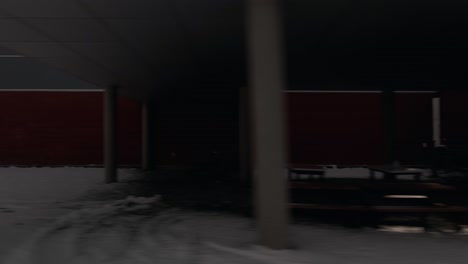 drone flying infront of building of bishop's university sports center during winter in lennoxville, sherbrooke, quebec, canada