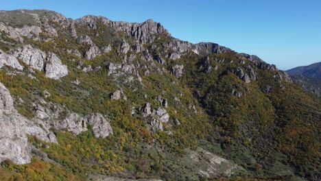 Jagged-Talysh-Mountains-with-fall-color-trees-on-slopes,-Azerbaijan