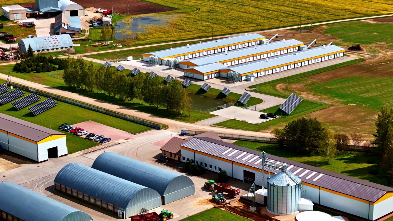Aerial view of large modern poultry farm or agricultural facility with solar panels