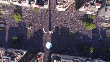 argentine people celebrating in 9th july avenue around obelisk the final victory of soccer world cup 2022, buenos aires