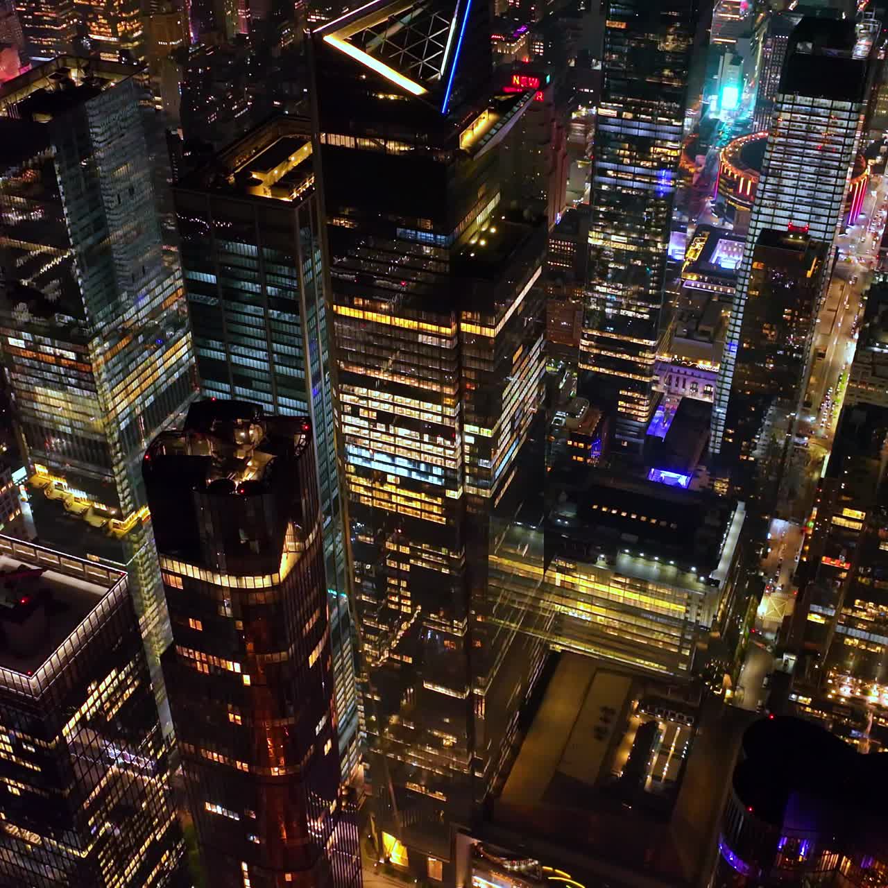 Stunning shiny sparkling skyscrapers towering over the light streets on New York. Impressive city scenery from drone footage rising up