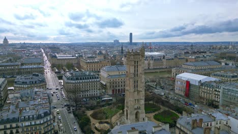 Saint-Jacques-Tower-and-square-with-Montparnasse-tower-in-background,-Boulevard-de-Sebastopol-at-Paris-in-France