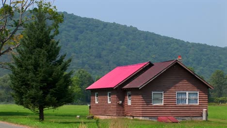 a cabin in the middle of a green field near the allegheny mountains in west virginia pennsylvania 1