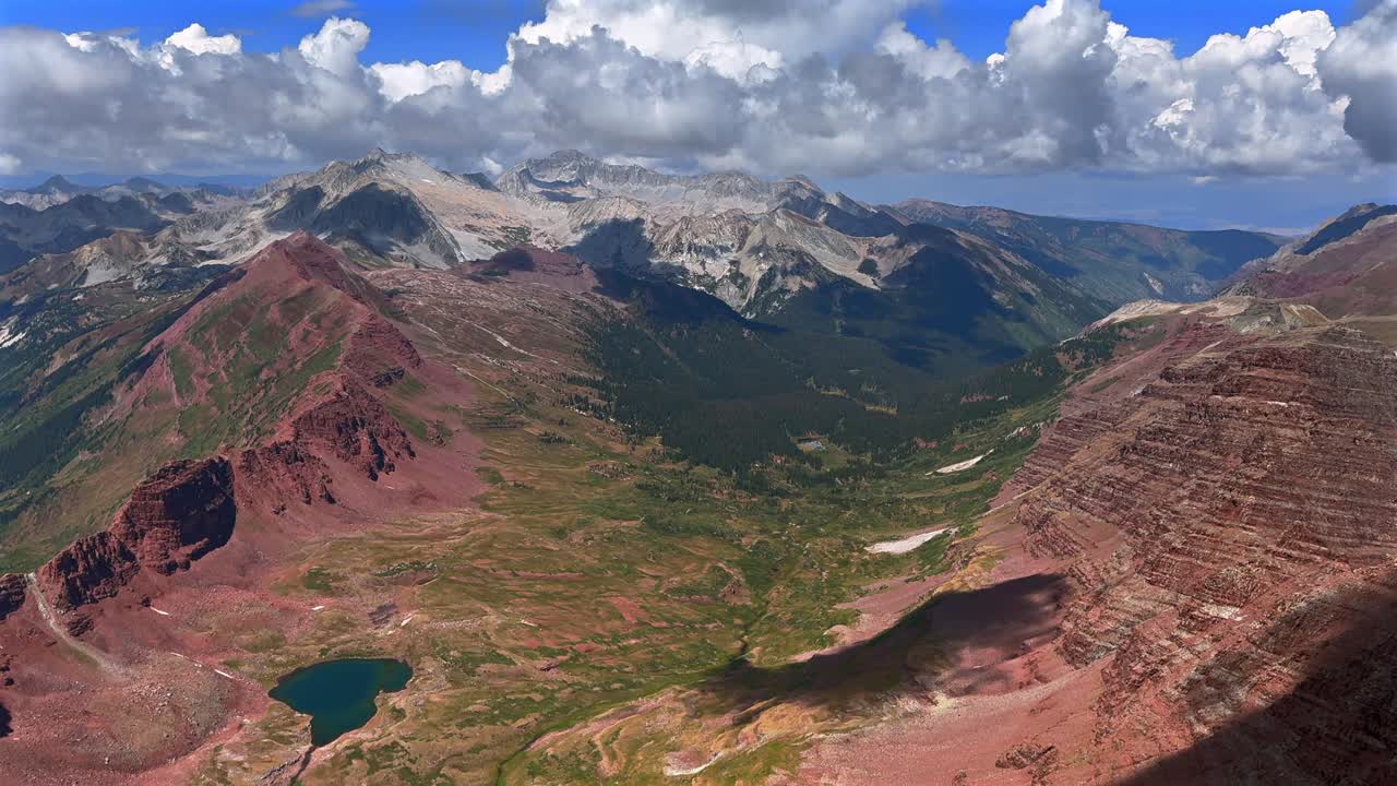 Aspen Snowmass Maroon Bells Wilderness valley Colorado summer panoramic view fourteener Elk Range Rocky Mountains rugged terrain Capitol Peak Mount Snowmass sunny blue sky clouds static shot