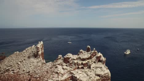 Aerial-shot-of-"La-Lobera"-with-some-boats-in-the-Partida-Island,-Baja-California-Sur