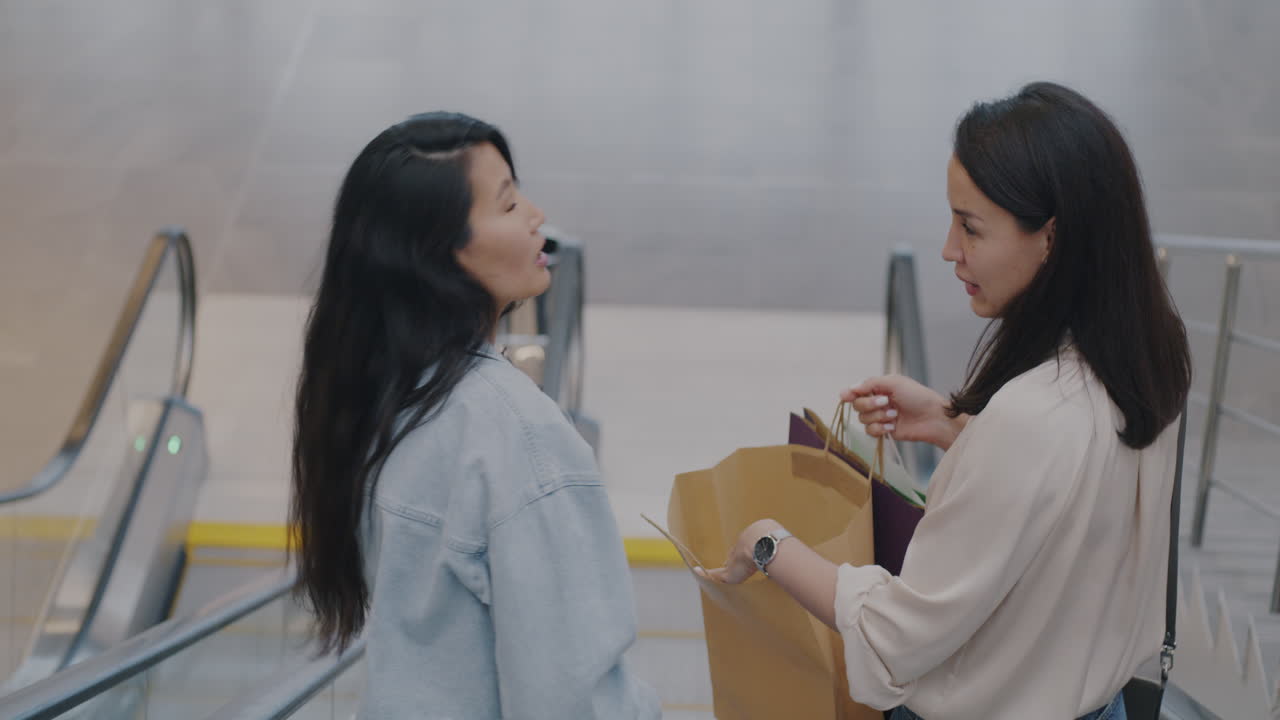 Two Women Shopping on an Escalator